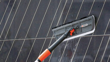 The GARDENA Cleansystem washing a solar panel.