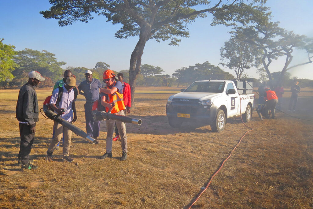 A group of men prepare to fight a fire with Husqvarna blowers