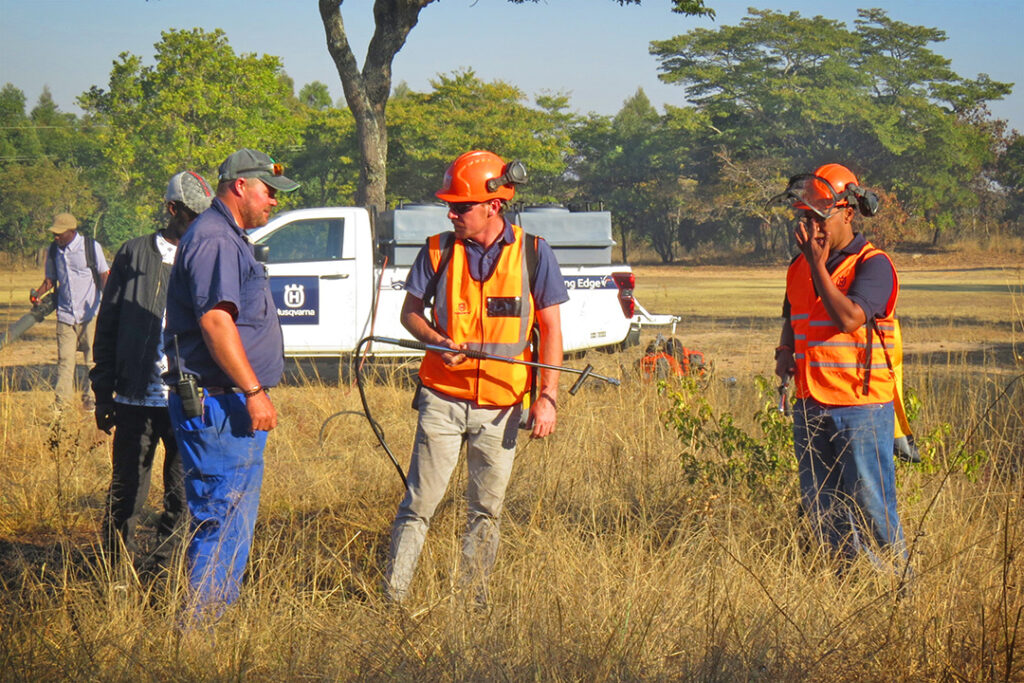 Three men prepare to fight a fire using a Hunter firefighter spray