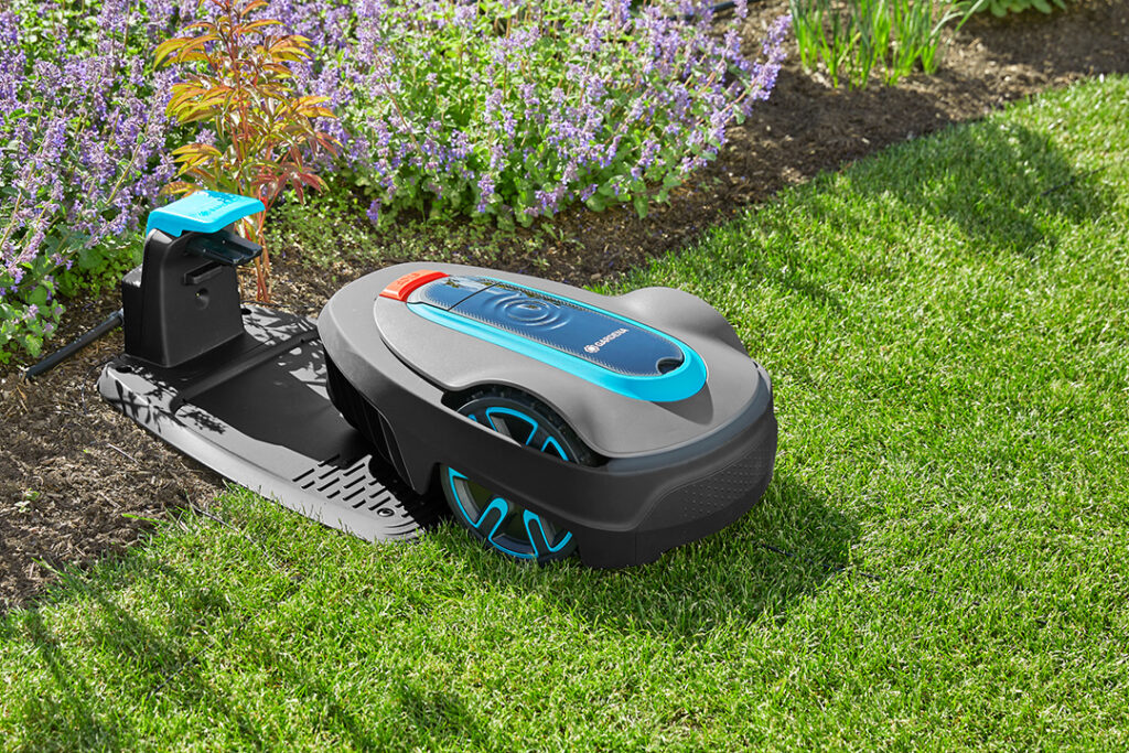 A Gardena SILENO minimo 750 robotic lawnmower on a green lawn.