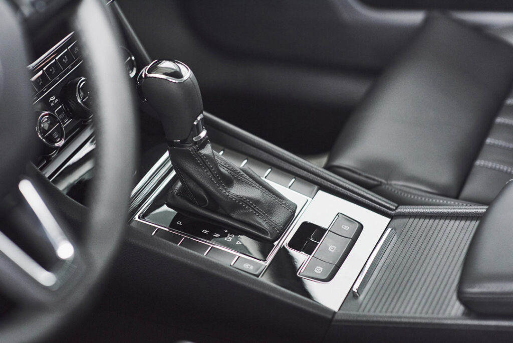 An automatic transmission shifter in the interior of a luxury car.