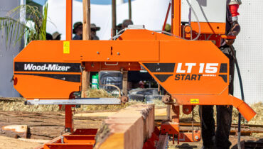 A wood-Mizer LT 15 Start sawmill cutting through a large log in Zimbabwe.