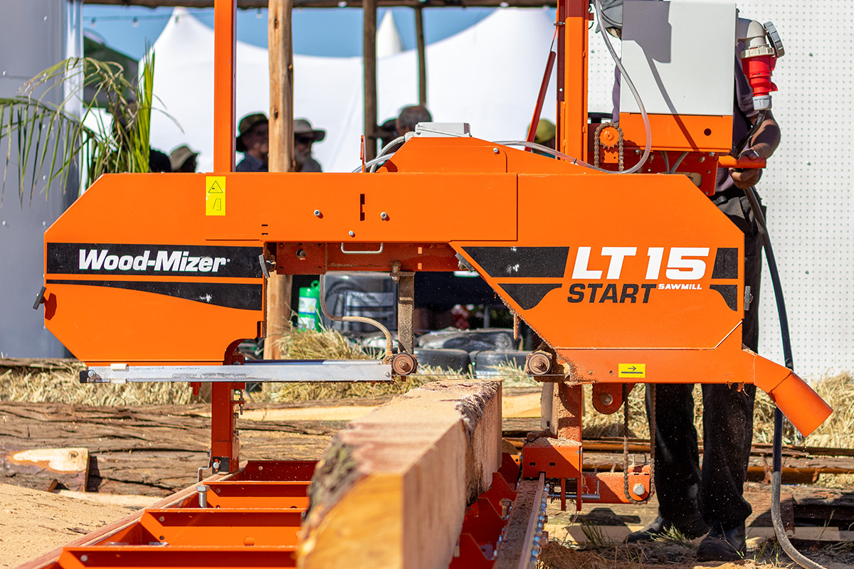 A wood-Mizer LT 15 Start sawmill cutting through a large log in Zimbabwe.